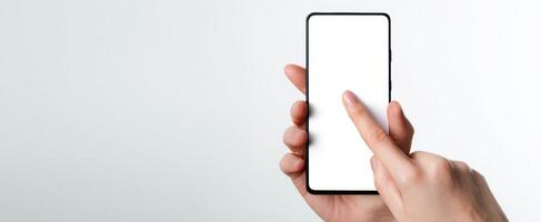 The hand interacting with a blank smartphone screen on a minimalistic background. photo