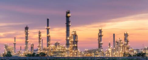 The industrial skyline illuminated by lights during a vibrant sunset. photo