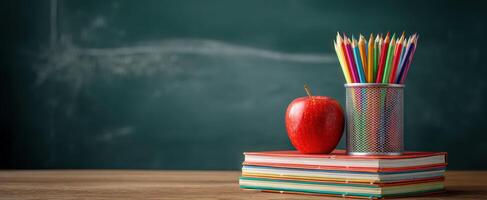 The vibrant arrangement of school supplies with apple and colorful pencils. photo