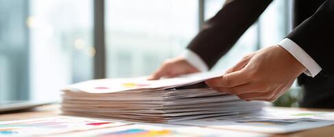 The professional stacking documents in a modern office workspace for effective organization photo