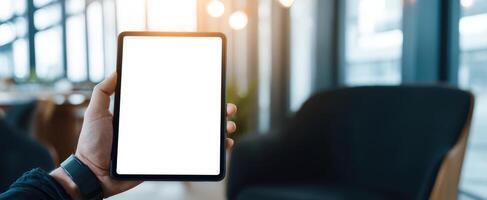 The tablet held in a modern workspace for digital content display. photo