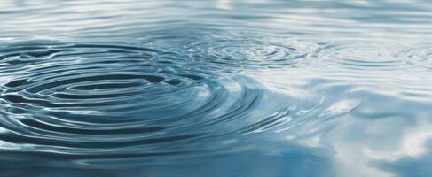 The tranquil water rippling with soft reflections under a serene sky photo