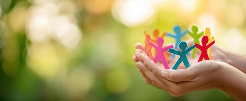 The vibrant paper cutouts representing community and togetherness in supportive hands. photo