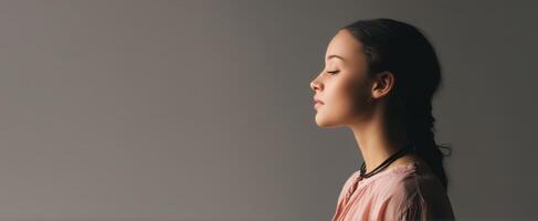 The woman in profile exuding a sense of calm and tranquility in a modern setting. photo