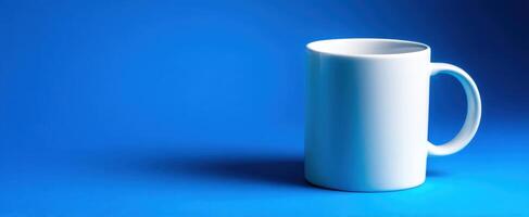 The elegant white mug on a vibrant blue background for perfect branding. photo