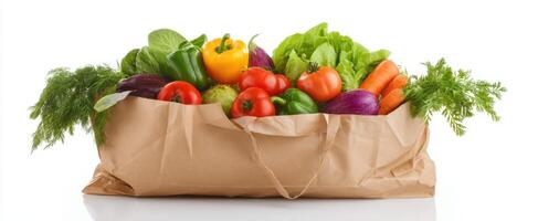 The colorful assortment of fresh vegetables in a paper grocery bag. photo