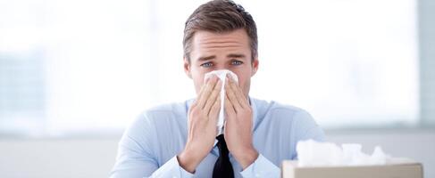 The man in the office dealing with illness and tissue in hand. photo