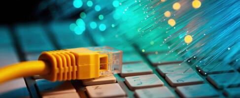 The vibrant connection of a yellow Ethernet cable and glowing fiber optics photo