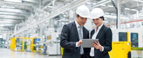 The professionals discussing strategies in a high-tech manufacturing facility. photo