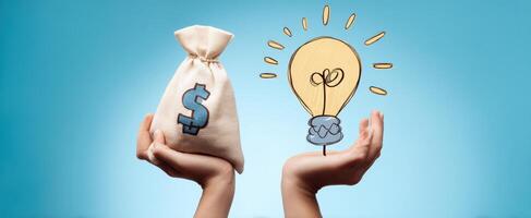 The hands holding money and a lightbulb symbolize innovation and financial success. photo