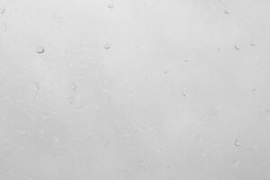 Rain drops on a window pane create a natural texture. photo