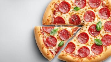 Pizza with juicy melted cheese and a cut slice, set against a gray background photo