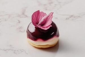 Minimalist profiterole topped with tropical guava ganache and crystallized hibiscus petal in refined monochrome styling photo