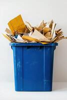 vertical photo blue recycling container filled with paper waste on white background. Use for environmental presentations, social media posts and educational resources