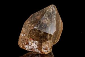Macro stone mineral Rutile in quartz on a black background photo