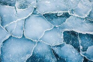 Artistic overhead view of ice textures with organic fractures and abstract lines, creating serene, frosty atmosphere in subtle blue hues photo