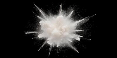 Dynamic flour explosion against black background photo