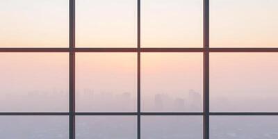 City skyline at sunrise through large glass window with soft hues photo