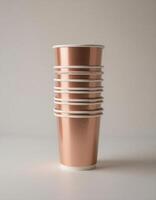 Stacked paper cups and plastic cups on minimal background photo