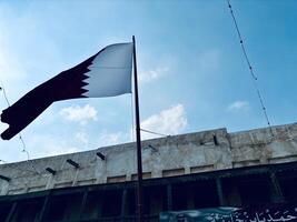 Qatar Flag on Shop Roof in Souq Waqif Street, Doha photo
