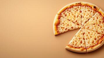 Sliced pizza with melted cheese on orange background, with copy space photo