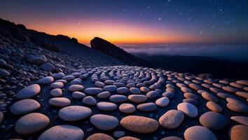 Arranged Pebbles Spiral Overlooking Mountain Sunset with Stars and Clouds photo