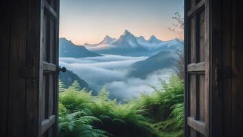 Open Wooden Door Framing Distant Mountain Peaks Above Fog Layer photo