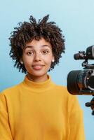 Influencer marketing and brand ambassadors concept. Confident woman posing with a camera against a colorful background. photo