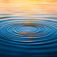 Serene, pure crystal water from gentle rain. Rippling water with colorful reflections at sunset. photo