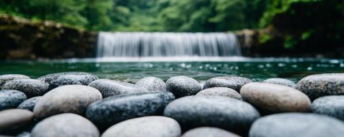 Serene, pure crystal water from gentle rain. Serene waterfall cascading over smooth stones in tranquil nature setting. photo