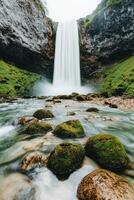 Serene waterfall cascading into a rocky stream surrounded by lush greenery. Pure water unpolluted concept. photo