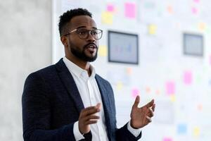 Professional man presenting ideas in a modern office setting. photo