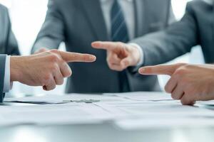 Businessmen arguing with fingers pointed at each other. photo