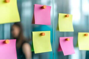 Colorful sticky notes on a glass surface in an office setting. photo