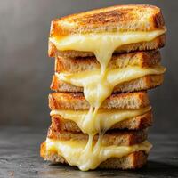 Melted cheese dripping from stacked grilled cheese sandwiches. photo