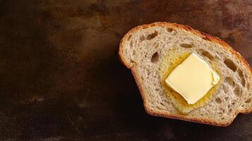 Butter on bread against a dark background. photo