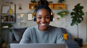 remote worker smiling while on call, open laptop, headphones and tidy background. photo