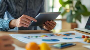 nutritionist consulting a client using a tablet and food diagram, office setup photo