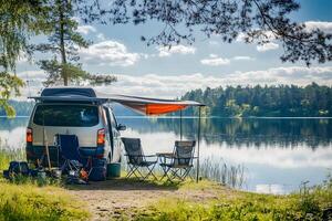 camping by tranquil lakeside with clear reflections, open hatchback van, folding chairs under canopy, fishing gear in view, relaxing mood, stock photo style, realistic,