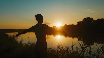 Silhouette of a person stretching against a sunset backdrop beautiful end of day routine photo