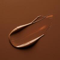 A swatch of smooth, brown foundation creates an elegant display of makeup texture and color. photo