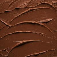 Close up of smooth, artistic brown chocolate paste creating beautiful abstract patterns. photo