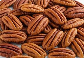 Delicious pecans piled together creating a beautiful and textured close-up display. photo