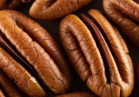 A detailed view of multiple pecan halves, showing their textured surfaces and color. photo