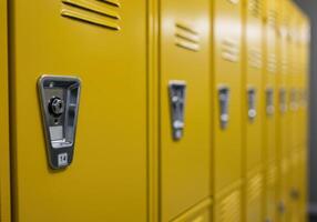 A close up shot of a row of vibrant yellow lockers, perfect for school or workplace use. photo