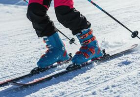 Close-up of skis and boots on a snowy slope, capturing the thrill of winter sports. photo