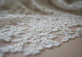 Exquisite lace with embedded pearls creates a captivating, elegant display of craftsmanship. photo