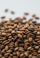 A detailed view of sesame seeds against a clean white backdrop, displaying texture. photo