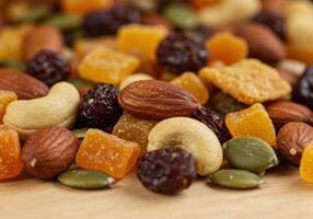 A colorful and appetizing mix of dried fruits and nuts, perfect for a quick and tasty snack. photo