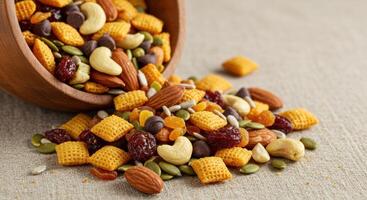 Close up of a wooden bowl overflowing with a colorful mixture of healthy snack items. photo